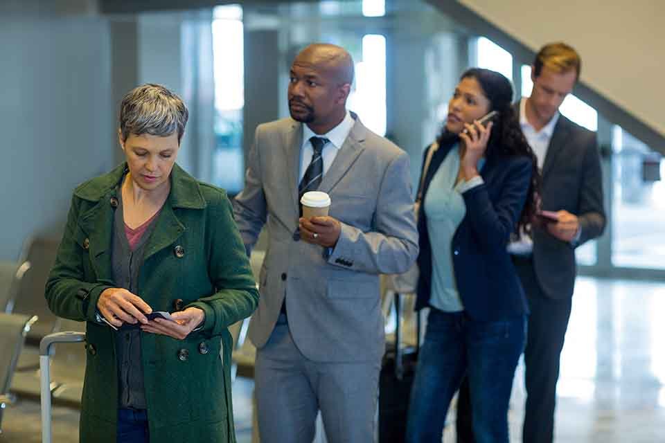business commuters waiting in queue at airport